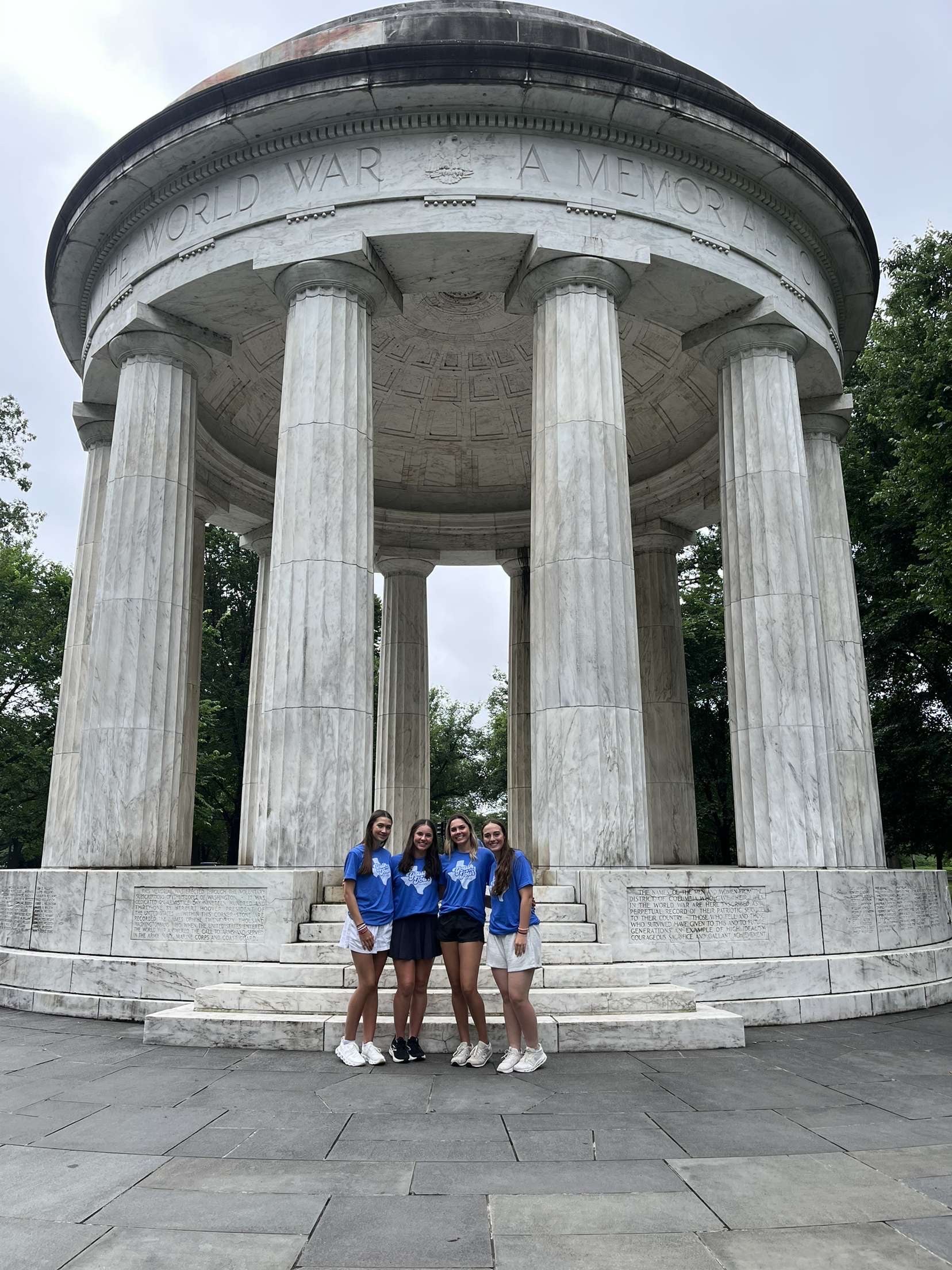 Three Youth Tour participants in front of D.C. monument.