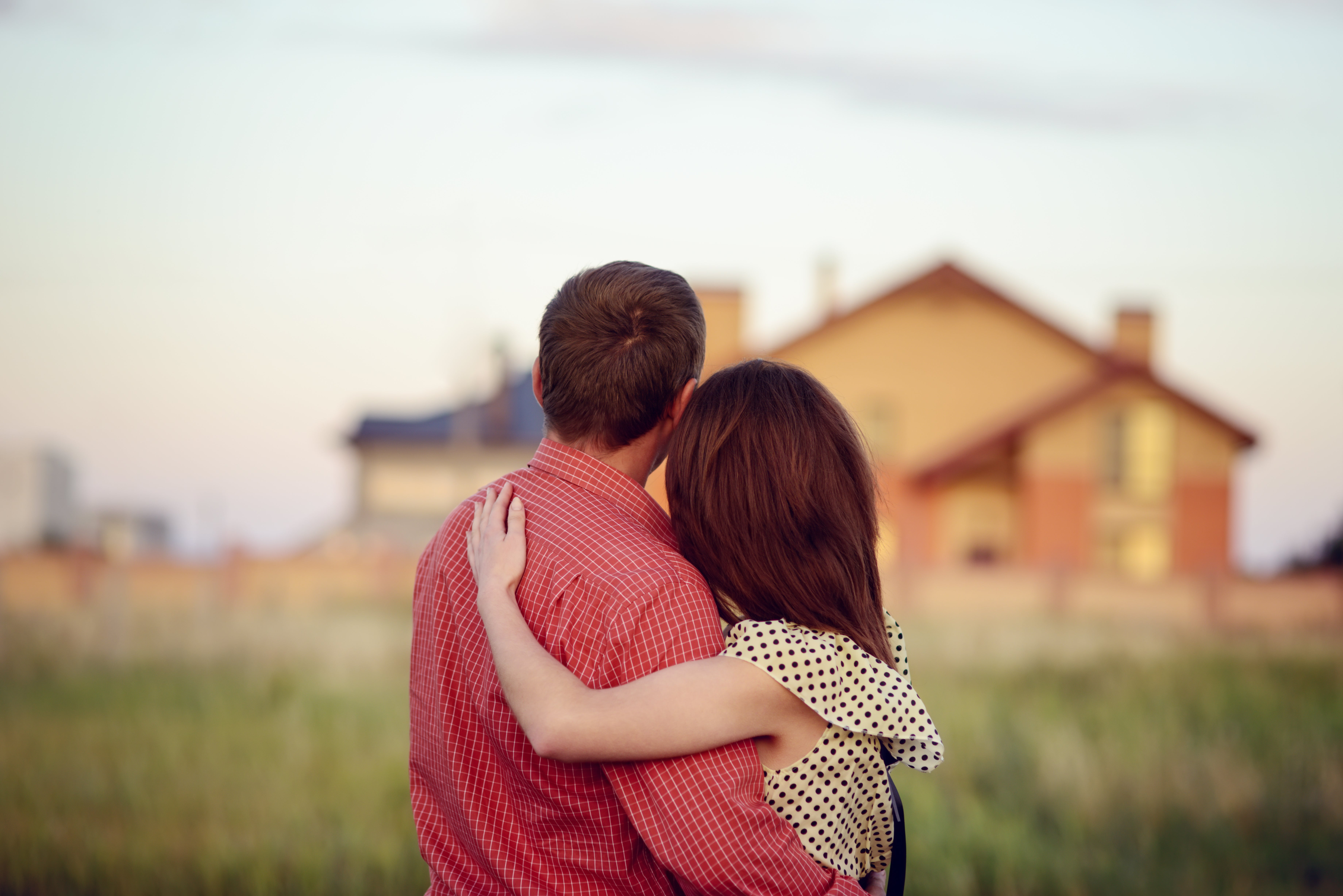 Homeowners standing by new house